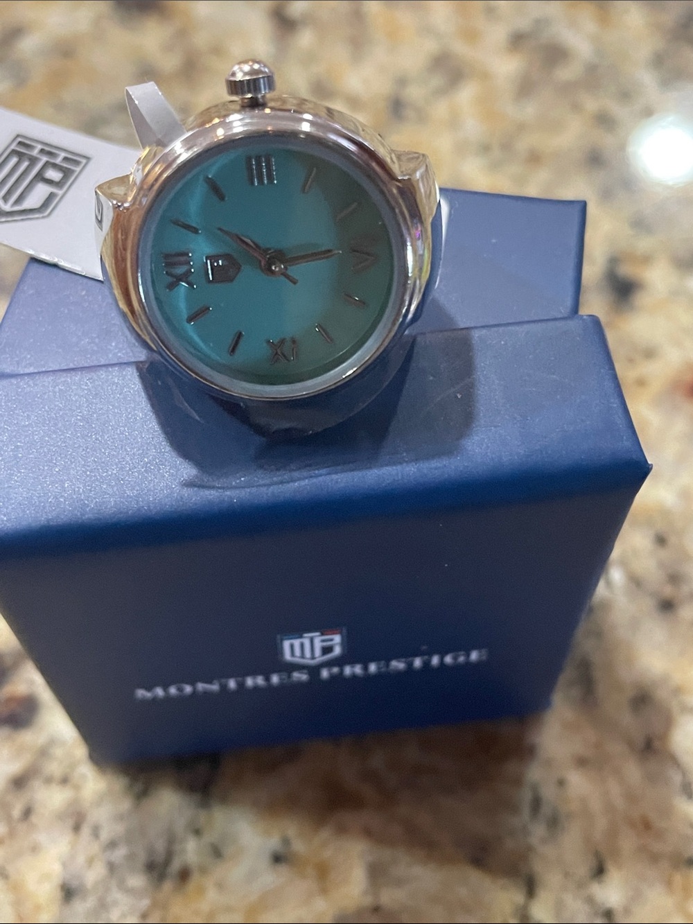 Montres Prestige Silver Ring Watch with Teal Dial